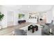 Open-concept living room featuring hardwood floors, modern furniture, and seamlessly connected to the kitchen at 1922 Cobb Trl, Parrish, FL 34219