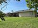 Beautiful backyard with a screened in porch area and lush green grass at 19358 Edgewater Dr, Port Charlotte, FL 33948