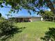 Lush backyard features a well-maintained lawn and privacy from mature trees at 19358 Edgewater Dr, Port Charlotte, FL 33948