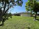 Spacious backyard with beautiful green grass and mature trees at 19358 Edgewater Dr, Port Charlotte, FL 33948