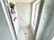 Bright bathroom featuring a shower with a window and safety features at 19358 Edgewater Dr, Port Charlotte, FL 33948
