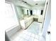 Bright bathroom features a dual sink vanity with ample counter space and tiled floors at 19358 Edgewater Dr, Port Charlotte, FL 33948