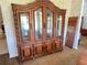 Dining room featuring a vintage china cabinet with detailed carvings and glass doors at 19358 Edgewater Dr, Port Charlotte, FL 33948