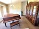 Dining room featuring a vintage china cabinet with detailed carvings next to a piano at 19358 Edgewater Dr, Port Charlotte, FL 33948