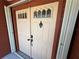 Elegant front door with decorative glass inserts and a classic design at 19358 Edgewater Dr, Port Charlotte, FL 33948