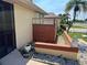 View of the front entrance featuring privacy panel, lush foliage, and meticulous rock landscaping with a decorative lion statue at 19358 Edgewater Dr, Port Charlotte, FL 33948