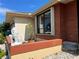 View of the front entrance featuring privacy panel, lush foliage, and meticulous rock landscaping with a decorative lion statue at 19358 Edgewater Dr, Port Charlotte, FL 33948