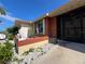 View of the front entrance featuring privacy panel, lush foliage, and meticulous rock landscaping with a decorative lion statue at 19358 Edgewater Dr, Port Charlotte, FL 33948