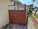 View of the front entrance featuring privacy panel, lush foliage, and meticulous rock landscaping with a decorative lion statue at 19358 Edgewater Dr, Port Charlotte, FL 33948