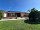 Inviting single-story home showcasing solar panels and a lush, green lawn under a bright, clear blue sky at 19358 Edgewater Dr, Port Charlotte, FL 33948
