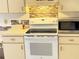 Kitchen features updated white appliances, modern backsplash, and white cabinets at 19358 Edgewater Dr, Port Charlotte, FL 33948