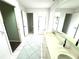 Bright main bathroom with dual sinks, walk-in shower, and separate water closet at 19358 Edgewater Dr, Port Charlotte, FL 33948