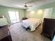 Spacious main bedroom with a sliding glass door, ceiling fan and ensuite bath at 19358 Edgewater Dr, Port Charlotte, FL 33948