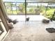Enclosed patio with tile flooring and views of the landscaped backyard at 19358 Edgewater Dr, Port Charlotte, FL 33948