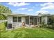 Green backyard featuring screened in porch, well maintained lawn, and mature trees at 2115 9Th W Ave # 3D, Bradenton, FL 34205