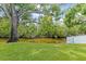 Expansive backyard featuring mature tree, lush green grass, and waterfront canal at 2115 9Th W Ave # 3D, Bradenton, FL 34205