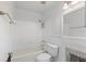 Bright, tiled bathroom features a tub/shower combo, toilet, and vanity with traditional fixtures at 2115 9Th W Ave # 3D, Bradenton, FL 34205