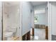 Bathroom leading into an empty room shows the space with visible cinder blocks and framing at 2115 9Th W Ave # 3D, Bradenton, FL 34205