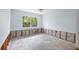 Spacious bedroom with window and visible cinder blocks with room framing along the bottom of the wall at 2115 9Th W Ave # 3D, Bradenton, FL 34205
