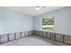 Large bedroom with window and visible cinder blocks with room framing along the bottom of the wall at 2115 9Th W Ave # 3D, Bradenton, FL 34205