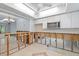 Open-concept kitchen with white cabinets, tiled floors, and exposed framing at 2115 9Th W Ave # 3D, Bradenton, FL 34205