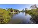 Scenic waterfront view featuring lush greenery and a modern building in the distance at 2115 9Th W Ave # 3D, Bradenton, FL 34205