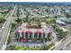 Aerial view of building complex with a pool, landscaping, and plenty of parking at 21405 Olean Blvd # 224, Port Charlotte, FL 33952