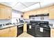 Updated kitchen features wood cabinets, granite counters and modern appliances at 21405 Olean Blvd # 224, Port Charlotte, FL 33952