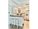 Bright kitchen with white cabinets, stainless steel appliances, breakfast bar, and wood flooring at 21405 Olean Blvd # 224, Port Charlotte, FL 33952