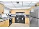 Bright kitchen features wood cabinets, granite counters and updated stainless steel appliances at 21405 Olean Blvd # 224, Port Charlotte, FL 33952
