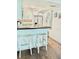 Kitchen features white cabinets, stainless steel appliances, a breakfast bar and stylish wood flooring at 21405 Olean Blvd # 224, Port Charlotte, FL 33952