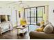 Bright living room featuring a comfortable sofa, sliding glass doors, and a ceiling fan at 21405 Olean Blvd # 224, Port Charlotte, FL 33952