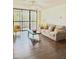 Inviting living room with a neutral-toned sofa, coffee table, and sliding glass doors to a balcony at 21405 Olean Blvd # 224, Port Charlotte, FL 33952