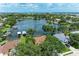 Aerial view showcasing lakefront property with lush landscaping, private docks, and serene water views at 220 39Th Ne St, Bradenton, FL 34208