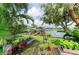 Tranquil backyard view overlooking a private dock, lush landscaping, and serene lake at 220 39Th Ne St, Bradenton, FL 34208