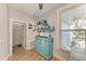 Charming bar area with custom shelving, a vintage blue cabinet, and natural light from the window at 220 39Th Ne St, Bradenton, FL 34208