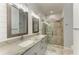 Beautiful bathroom featuring a large shower with bench, double sinks, and wainscoting at 220 39Th Ne St, Bradenton, FL 34208