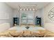 Well-lit dining area featuring a wooden table, modern lighting, and coastal-inspired decor at 220 39Th Ne St, Bradenton, FL 34208