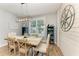 Elegant dining room with a rustic wood table, stylish decor, and plenty of natural light at 220 39Th Ne St, Bradenton, FL 34208