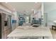 Kitchen boasts an island with seating, stainless steel appliances, tiled backsplash, and views of the living space at 220 39Th Ne St, Bradenton, FL 34208