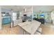 Kitchen with an island, stainless steel appliances, tiled backsplash, and an open layout to the living room at 220 39Th Ne St, Bradenton, FL 34208