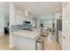 Open concept kitchen with stainless steel appliances, marble countertops, and a view into the dining room at 220 39Th Ne St, Bradenton, FL 34208