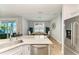 Bright kitchen with stainless steel appliances, marble countertops, and an open dining area at 220 39Th Ne St, Bradenton, FL 34208