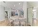 Kitchen featuring an island with seating, stainless steel appliances, tiled backsplash, and wood floors at 220 39Th Ne St, Bradenton, FL 34208