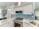 Modern kitchen boasting stainless steel appliances, tiled backsplash, and a gas cooktop at 220 39Th Ne St, Bradenton, FL 34208