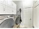 Well-organized laundry room with white cabinets and modern washer and dryer at 220 39Th Ne St, Bradenton, FL 34208