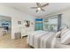 Comfortable main bedroom with ceiling fan, view of water, and beach-themed decor at 220 39Th Ne St, Bradenton, FL 34208