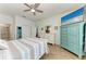 Comfortable main bedroom features beach themed decor, wood floors and a ceiling fan at 220 39Th Ne St, Bradenton, FL 34208