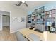 Bright office space featuring built-in shelving, desk, and ceiling fan at 220 39Th Ne St, Bradenton, FL 34208