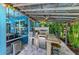 The outdoor kitchen features a built-in grill, bar seating, and a fun tiki bar atmosphere at 220 39Th Ne St, Bradenton, FL 34208
